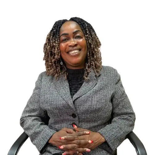 view of a coastal Mediterranean village on a hillside, with small boats in the water.