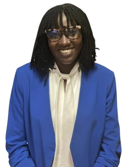 view of a coastal Mediterranean village on a hillside, with small boats in the water.