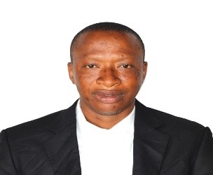 view of a coastal Mediterranean village on a hillside, with small boats in the water.